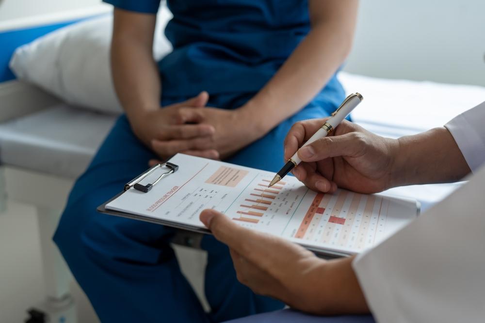 A prostate cancer specialist reviews test results with a patient. 