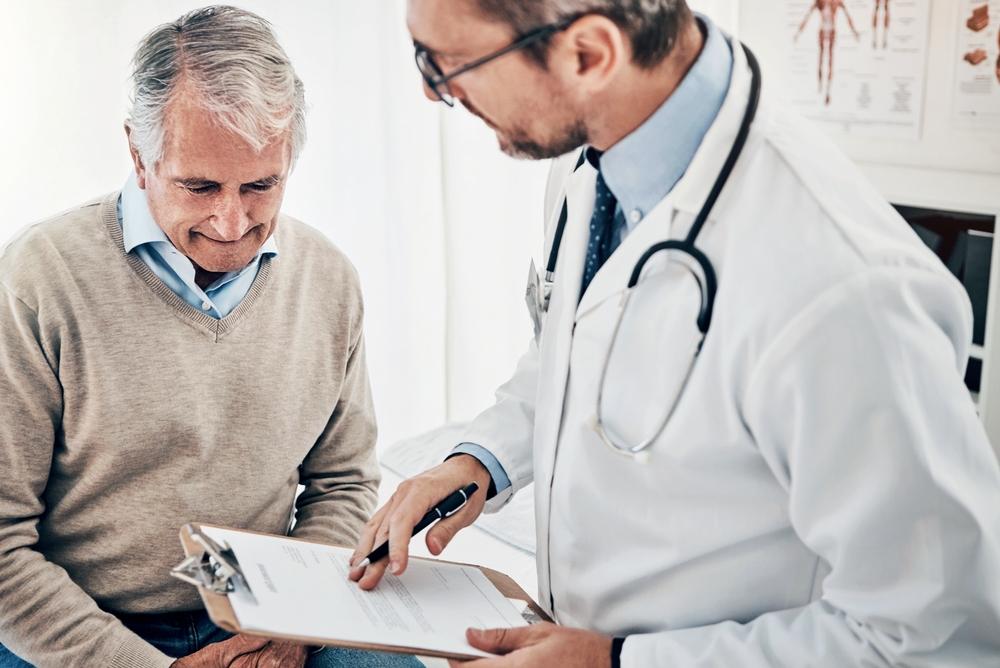 A prostate cancer specialist speaks with a patient.